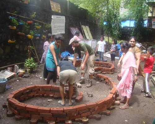 The residents of Kores Housing Society in Mumbai lay the foundation for a community garden in their backyard